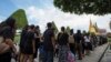 Thai mourners stand in line to pay their respect to the body of the late King Bhumibol Adulyadej at the Grand Palace in Bangkok, Thailand, Oct. 15, 2016.