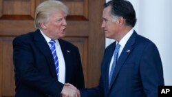 President-elect Donald Trump and Mitt Romney shake hands as Romney leaves Trump National Golf Club Bedminster in Bedminster, N.J., Nov. 19, 2016. 