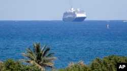 FILE - Carnaval's Holland America cruise ship Zaandam approaches Port Everglades during the new coronavirus pandemic, April 2, 2020, in Fort Lauderdale, Fla. 
