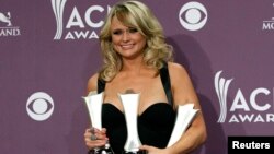 Miranda Lambert poses with her awards for female vocalist of the year, song of the year, and single record of the year backstage at the 48th ACM Awards in Las Vegas, April 7, 2013.