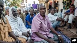 In this Aug. 28, 2014 photo, Hissein Abakar, sits in Boda, Central African Republic. Hissein, lost his 14-year-old son Ali when he was shot in the head by Christian militia fighters in Boda and attacked with machetes. In the fighting that ensued, at least eight others were killed. More than 5,000 people have died in sectarian violence in the Central African Republic since December, according to an Associated Press tally. (AP Photo/Sylvain Cherkaoui)