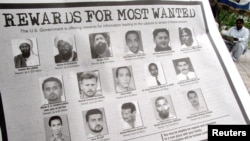 FILE - In notice offering rewards for information leading to the capture of most wanted terrorists, Anas al Liby is bottom row, second from left.