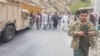 Anti-Taliban commanders walk on a road in Panjshir Valley, Afghanistan, Aug. 23, 2021. (Aamaj News Agency via Reuters)