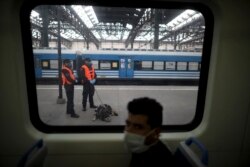 Police guard a train station during a government-ordered lockdown to curb the spread of the new coronavirus, in Buenos Aires, Argentina, Friday, April 24, 2020. (AP Photo/Natacha Pisarenko)