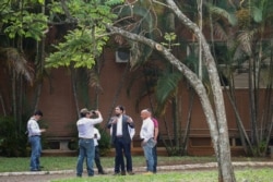Supporters of Venezuela's opposition leader Juan Guaido record a video from the grounds of the Venezuelan embassy in Brasilia, Brazil, Nov. 13, 2019.