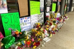 FILE - A makeshift memorial is seen March 19, 2021, in Acworth, Ga., in the aftermath of shootings that left eight people dead at three metro Atlanta massage businesses.