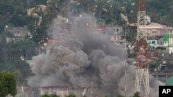 Debris flies as Philippine Air Force fighter jets bomb suspected locations of Muslim militants as fighting continues in Marawi city, southern Philippines, June 9, 2017. 
