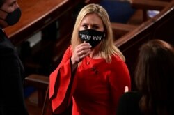 FILE - U.S. Rep. Marjorie Taylor Greene, R-Ga., wears a "Trump Won" face mask as she arrives at the House floor to take her oath of office as a new member of the 117th House of Representatives in Washington, D.C. Jan. 3, 2021.