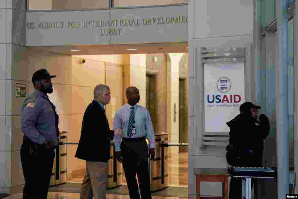 Security personnel work, as the USAID building sits closed to employees after a memo was issued advising agency personnel to work remotely, in Washington.