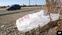 In this file photo taken on Oct. 25, 2013, a plastic shopping bag liters the roadside in Sacramento, Calif. (AP Photo/Rich Pedroncelli)