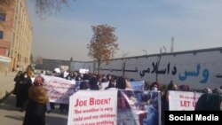 Women are shown on Dec. 28 walking through the streets of Kabul protesting their treatment under the new Taliban government.