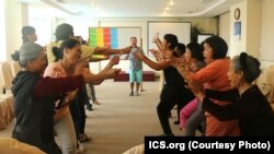 Participants react at a Parents, Families and Friends of Lesbians and Gays meeting in Vietnam.