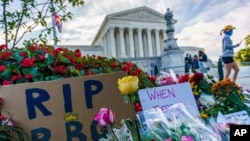 People gather at the Supreme Court on the morning after the death of Justice Ruth Bader Ginsburg, 87, Sept. 19, 2020 in Washington. 