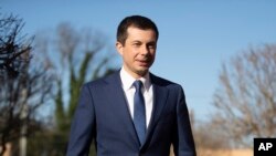 FILE - Democratic presidential candidate and former South Bend, Ind. Mayor Pete Buttigieg walks to speaks with members of the media, March 1, 2020, in Plains, Ga.