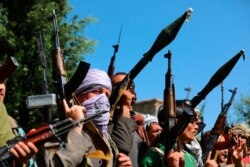 FILE - Afghan militiamen join Afghan defense and security forces in Kabul, June 23, 2021. Taliban gains in north Afghanistan have driven the government to resurrect militias whose histories have featured chaos and widespread killings.