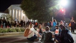 People gather at the Supreme Court to honor the late Justice Ruth Bader Ginsburg, Saturday, Sept. 19, 2020, in Washington. (AP Photo/Cliff Owen)