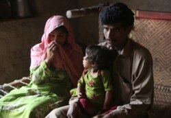Pakistan's Tariq Ali, 30 along with his wife Parveen and 3-year-old Ume Kulssom all infected with HIV sit at their home near Ratodero, May,16, 2019.