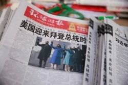 A copy of the Global Times newspaper featuring an image of U.S. President Joe Biden and Vice President Kamala Harris on its front page is seen at a news stand in Beijing, China, Jan. 21, 2021.