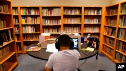FILE - A Los Angeles Unified School District student attends an online class at Boys & Girls Club of Hollywood in Los Angeles, Aug. 26, 2020.