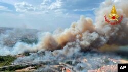 In this photo released by the Italian Firefighters, a view of a violent wildfire that burned the historical pinewood in Pescara, central Italy, Aug. 1, 2021.