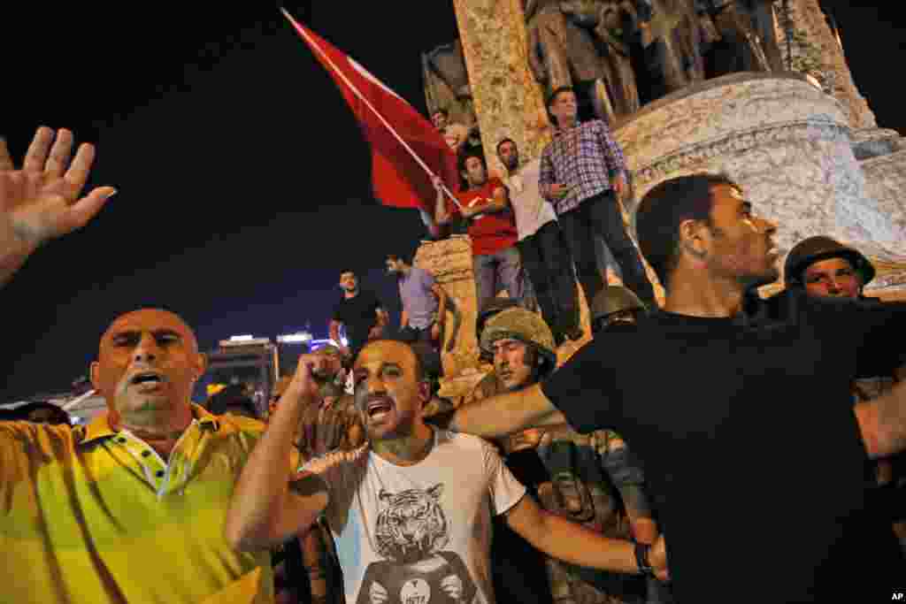 Supporters of Turkey's President Recep Tayyip Erdogan protest in front of soldiers in Istanbul's Taksim square, early Saturday, July 16, 2016.
