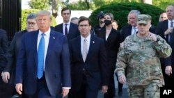 FILE - In this June 1, 2020 file photo, President Donald Trump departs the White House to visit outside St. John's Church, in Washington. Walking behind Trump, Secretary of Defense Mark Esper and Gen. Mark Milley, chairman of the Joint Chiefs of Staff. 