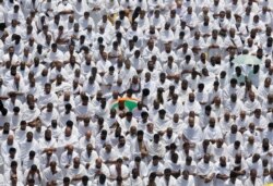 Hundreds of thousands of Muslim pilgrims pray outside Namira Mosque in Arafat during the annual hajj pilgrimage, near the holy city of Mecca, Saudi Arabia, Saturday, Aug. 10, 2019.