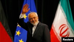FILE - Iranian Foreign Minister Mohammad Javad Zarif waves after a plenary session at the United Nations building in Vienna.