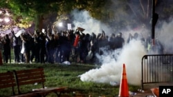 Tear gas billows as demonstrators gather in Lafayette Park to protest the death of George Floyd, May 31, 2020, near the White House in Washington.