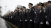 Police officers line the streets before the funeral of Officer Wenjian Liu in the Brooklyn borough of New York, Jan. 4, 2015. 