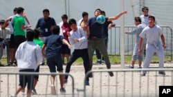 FILE - Migrant children play soccer at the Homestead Temporary Shelter for Unaccompanied Children in Homestead, Fla., April 19, 2019.