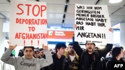 FILE - People take part in a demonstration against the deportation of some 50 Afghan refugees from Munich airport, southern Germany, Feb. 22, 2017. The Afghan government is asking the Trump administration to halt the deportation of Afghan nationals in the United States.