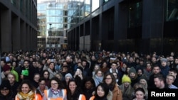 Workers stand outside the Google offices after walking out as part of a global protest over workplace issues in Dublin, Ireland, Nov. 1, 2018. 