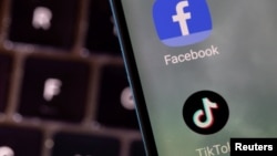 FILE - Facebook and TikTok apps are seen on a smartphone in this illustration taken Feb. 27, 2022. 