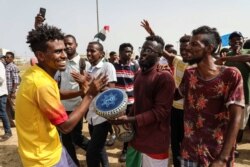 FILE - People take part in a rally condemning the deadly June crackdown on pro-democracy protesters in Khartoum, Sudan, July 18, 2019.