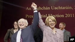 Michael Higgins, left, and his wife Sabina react after he won in the first count in the election to be next President of Ireland at Dublin Castle, Ireland, October 28, 2011.