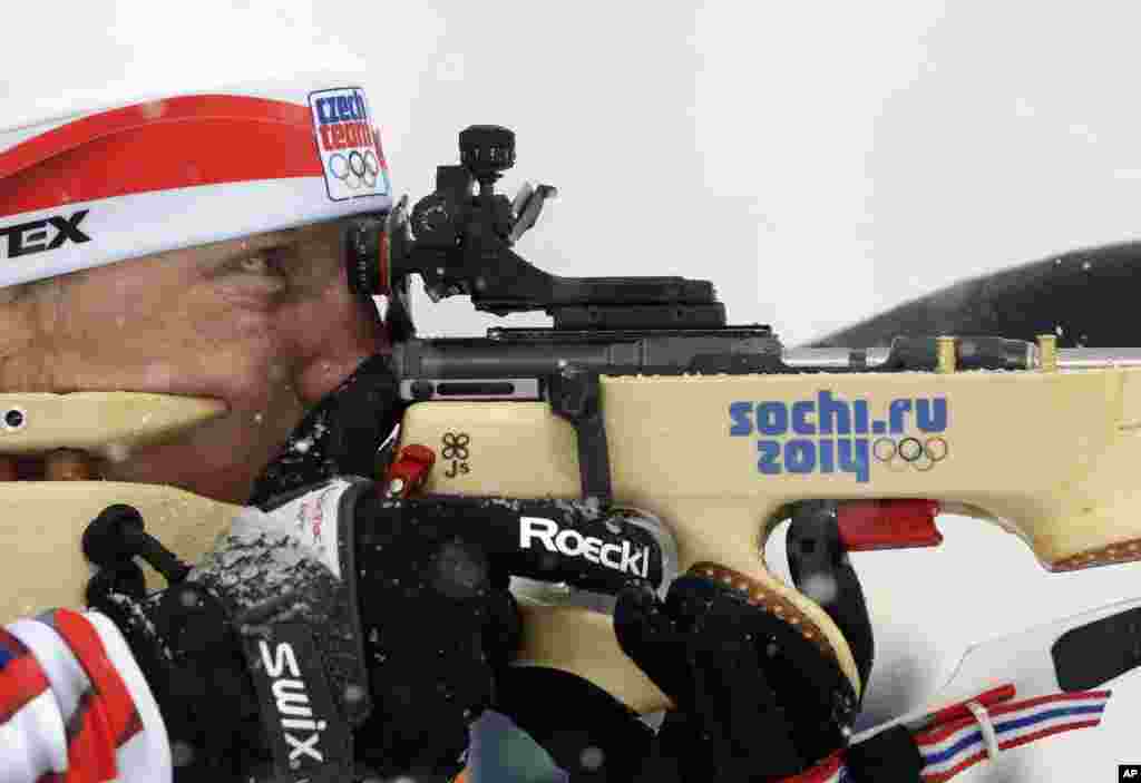 Czech Republic's Ondrej Moravec shoots during the men's biathlon 15k mass-start, at the 2014 Winter Olympics, Feb. 18, 2014.