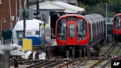 A police forensic tent stands on the platform next to the train on which a homemade bomb exploded at Parsons Green subway station in London, Sept. 15, 2017.