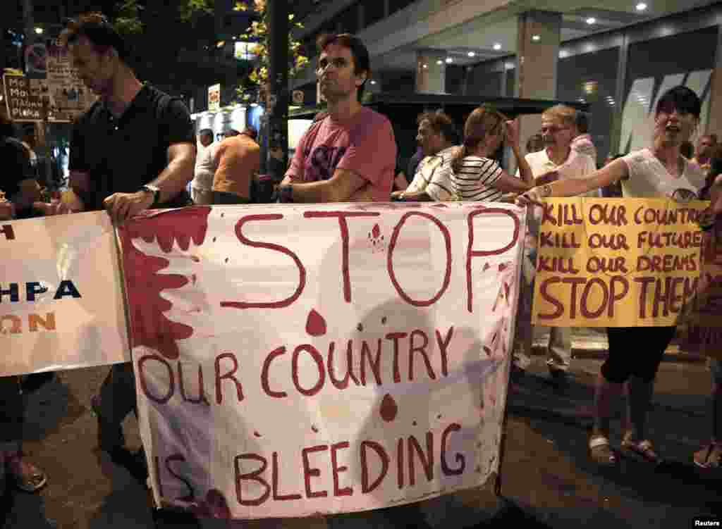 Protesters take part in a demonstration against public sector layoffs, which the government has promised its international lenders in exchange for bailout funds, in Athens, July 15, 2013.