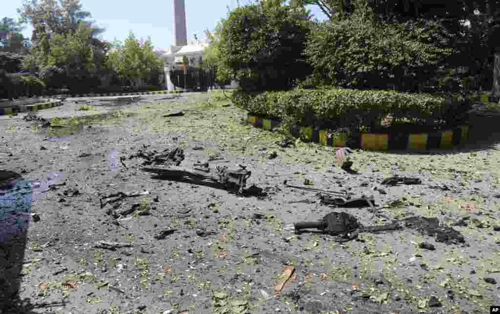 The Syrian official news agency SANA photo shows the remains of a vehicle and other debris where they landed after a car exploded at Syria&#39;s army command headquarters in Damascus, Syria, Sept. 26, 2012. 