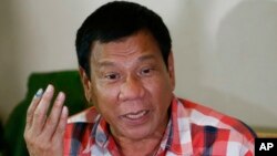 Front-running presidential candidate Mayor Rodrigo Duterte gestures during his second news conference after voting in a polling precinct at Daniel R. Aguinaldo National High School, Matina district, his hometown in Davao city in southern Philippines, May