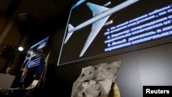 Visuals are displayed during a news conference by Russian arms maker Almaz-Antey at which it presented the results of its probe of last year's downing of Malaysia Airlines flight MH17 over eastern Ukraine, in Moscow, Russia, Oct. 13, 2015. 