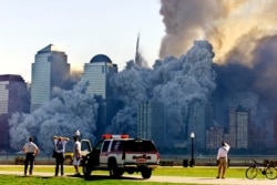 FILE - The remaining tower of New York's World Trade Center, Tower 2, collapses in a cloud of dust and debris Sept. 11, 2001. Some conspiracy theorists believe the towers were demolished by powerful, unknown people or forces.