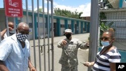 An official turns away two voters at a voting center lacking ballots in Carolina, Puerto Rico, Aug. 9, 2020.