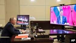 Russian President Vladimir Putin talks with Chinese President Xi Jinping via videoconference at the Novo-Ogaryovo residence outside Moscow, Dec. 15, 2021. The Kremlin said Xi supported Putin's push to get Western security guarantees precluding NATO's eas