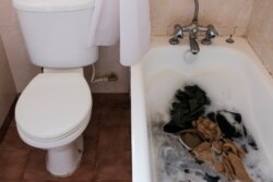 FILE - Laundry sits in the bathtub of a government-designated quarantine facility in Nairobi, March 29, 2020.