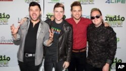 FILE - Eli Maiman, from left, Nicholas Petricca, Kevin Ray and Sean Waugaman of the band Walk the Moon pose for photographers.