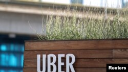 FILE - Signage for an Uber hub is seen in Redondo Beach, California, March 25, 2019.