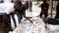 FILE - Men read newspapers on a street in Lagos, Nigeria, July 26, 2014. Military officers have seized newspapers from newsstands in the city of Aba for reportedly publishing materials aimed at inciting readers.