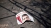 A ripped poster of Egypt's ousted President Mohamed Morsi lies on the ground in the courtyard of the Rabaah Al-Adawiya mosque in Nasr city, Cairo, August 21, 2013. 